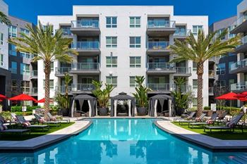 Resort-like grand courtyard with outdoor pool, in-pool chaise lounges and areas for sunning