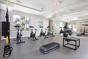 San Jose apartment for rent - A gym with exercise equipment and a bench.