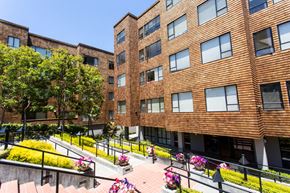 San Francisco apartment for rent - a large brick building with trees in the background