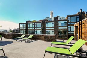 San Francisco apartment for rent - a rooftop deck with lounge chairs and a fire pit