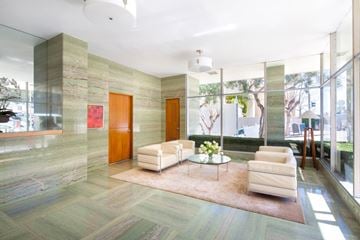 San Francisco apartment for rent - a living room with white furniture and large glass windows
