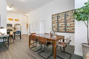 Stamford apartment for rent - a dining area with a wooden table and chairs and a kitchen in the background