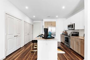 Prosper apartment for rent - a kitchen with white walls and wood floors