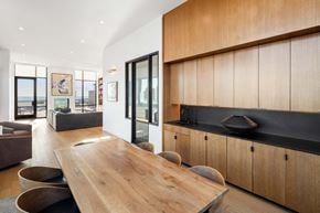 New York apartment for rent - a kitchen with wooden cabinets and a wooden table