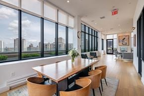 New York apartment for rent - a dining room with large windows and a table with chairs
