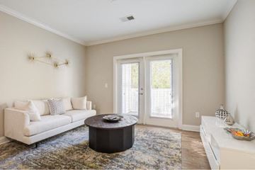 Manassas Park apartment for rent - A living room with a white couch and a coffee table.