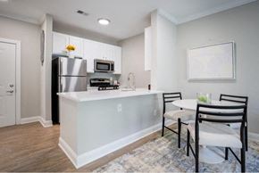 Manassas Park apartment for rent - a kitchen with an island and a table with chairs
