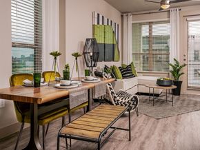 Fort Worth apartment for rent - Living room with dining table at The Kelley at Samuels Ave, Fort Worth, 76102