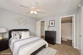 Indianapolis apartment for rent - a bedroom with a bed and a ceiling fan