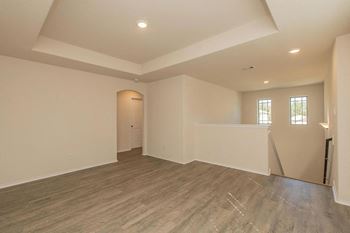 Bright vacant and unfurnished room with hardwood floor