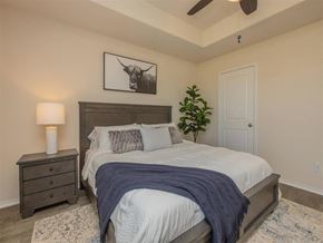 Conroe apartment for rent - Bedroom with bed and nightstand at The Village at Granger Pines, Conroe, 77302