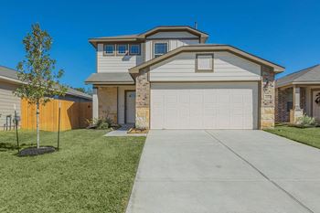 Property exterior view with green front yard and attached garage