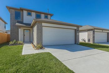 Lush green front yard and attached garage