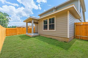 A house with a wooden fence in front of it