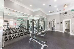 Raleigh apartment for rent - a fitness room with a lot of weights in it