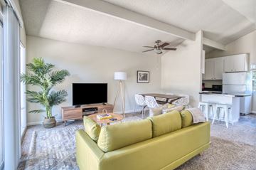 Walnut Creek apartment for rent - A living room with a yellow couch and a television.