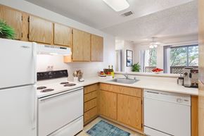 Martinez apartment for rent - a kitchen with white appliances and wooden cabinets
