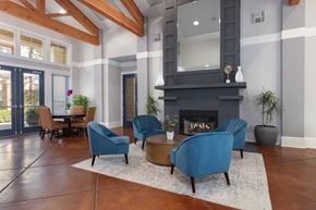 Vacaville apartment for rent - a living room with blue chairs and a fireplace