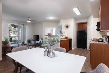 Vacaville apartment for rent - A modern kitchen with a dining table and chairs in the foreground.