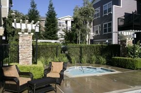 Vacaville apartment for rent - a hot tub in a backyard with patio furniture