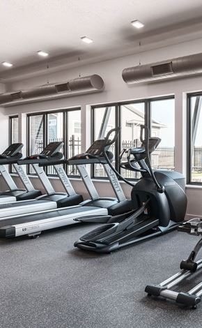 Saratoga Springs townhouse for rent - a gym with treadmills and other cardio equipment on the floor