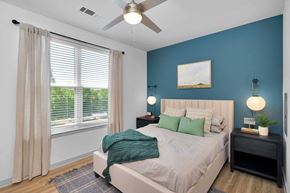 Charlotte apartment for rent - a bedroom with a bed and a ceiling fan