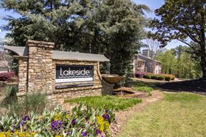 Atlanta apartment for rent - a stone building with a lakeside sign and a fountain in a garden