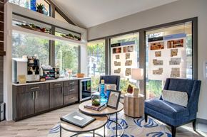 Atlanta apartment for rent - a living room with blue chairs and a coffee bar and large windows