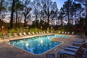 Atlanta apartment for rent - the pool is surrounded by lounge chairs at the resort