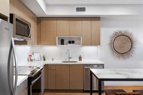 Oakland apartment for rent - a kitchen with wooden cabinets and a sink and a refrigerator