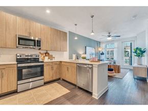 Charlotte apartment for rent - a large kitchen with stainless steel appliances and wooden cabinets
