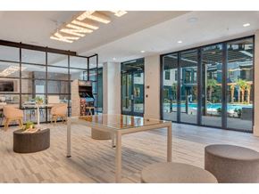 Charlotte apartment for rent - a lobby with a table and chairs and a pool