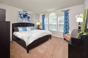 Elkridge apartment for rent - a bedroom with a bed and a large window