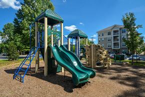 Ellicott City apartment for rent - a playground with a slide and climbing equipment in a park