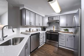 Ellicott City apartment for rent - a kitchen with stainless steel appliances and white counter tops