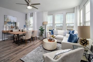 Ellicott City apartment for rent - an open living room and dining room with a couch and a table