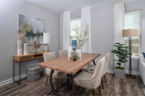 Ellicott City apartment for rent - a dining room with a wooden table and white chairs