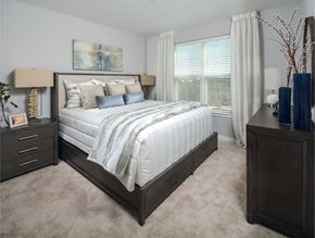 Ellicott City apartment for rent - a bedroom with a bed and a dresser and a window