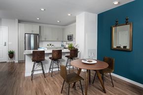Stoneham apartment for rent - Model kitchen and dining room at Alta Clara apartments in Stoneham, MA, featuring wood grain flooring.