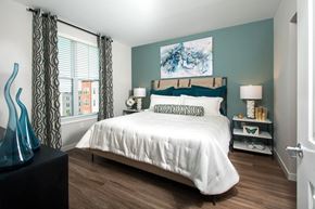Stoneham apartment for rent - a bedroom with a bed and a large window
