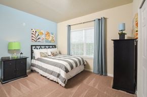 Frederick apartment for rent - a bedroom with a bed and a large window