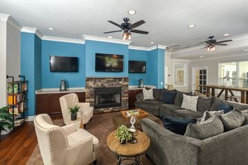Frederick apartment for rent - a living room with couches and chairs and a fireplace