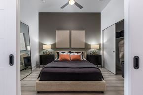 Lakewood apartment for rent - a bedroom with a bed and a ceiling fan