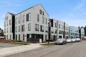 Gresham apartment for rent - a row of apartment buildings on a city street with cars