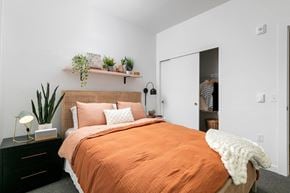 Gresham apartment for rent - a bedroom with an orange bed and a white closet
