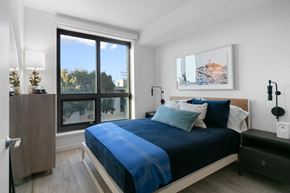 San Francisco apartment for rent - a bedroom with a bed and a large window