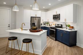 Brookhaven apartment for rent - a kitchen with blue and white cabinets and a white counter top