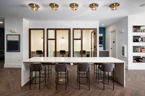 Brookhaven apartment for rent - a dining room with a large white table and chairs