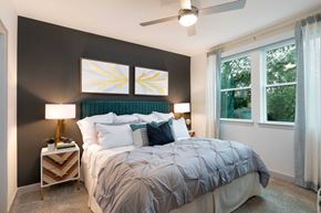 Houston apartment for rent - a bedroom with a bed and a ceiling fan