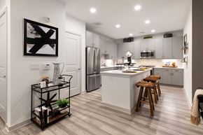 Houston apartment for rent - a kitchen with a center island and a stainless steel refrigerator
